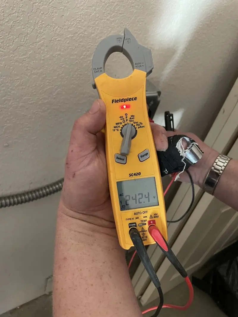 Voltage testing with clamp meter during Whole House Surge Protector in Plymouth